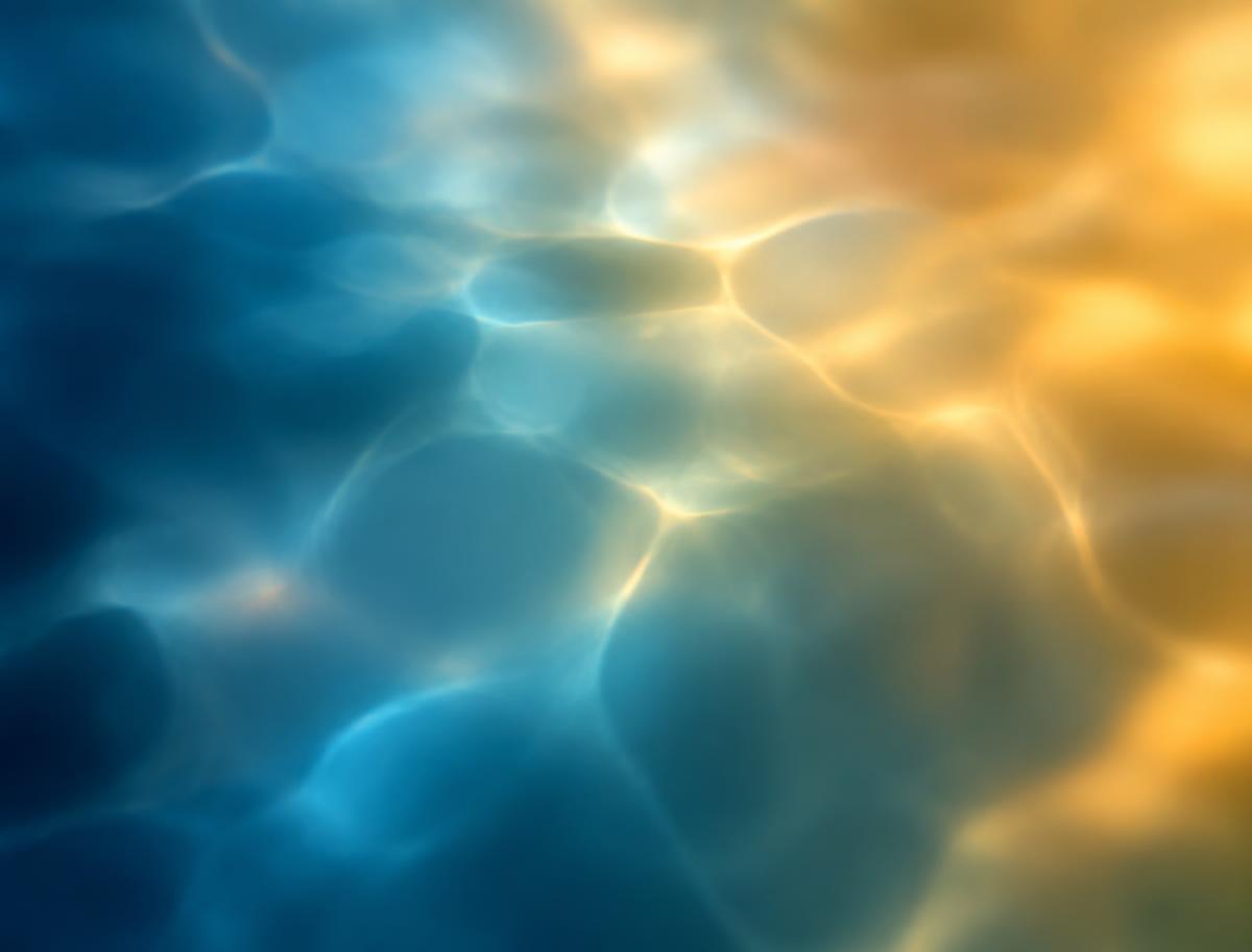 Abstract light refracting through water in calm blue and warm amber tones